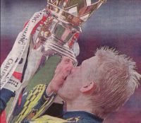 Peter kissing the Premiership trophy.